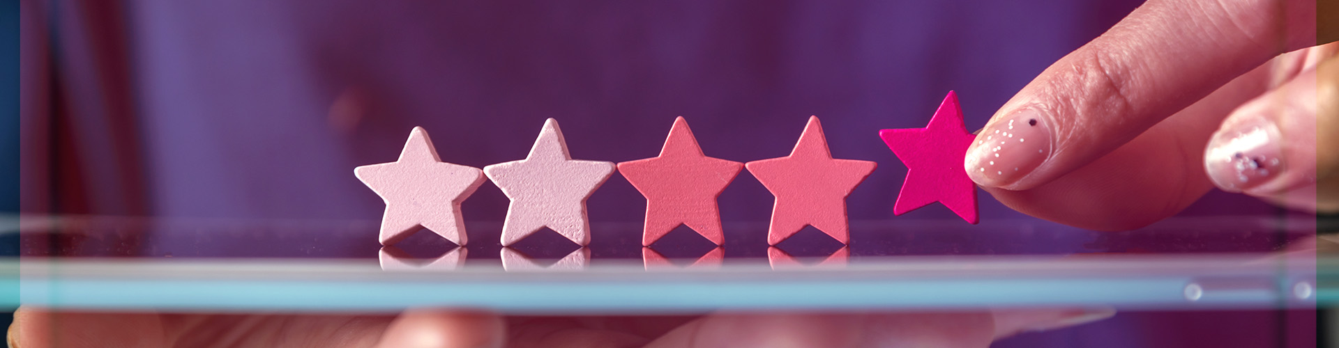 Hand placing stars down to represent categories banner