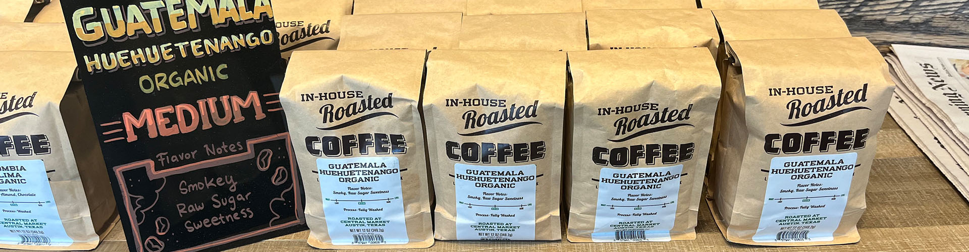 Banner featuring locally roasted coffee bags on display on the store shelves