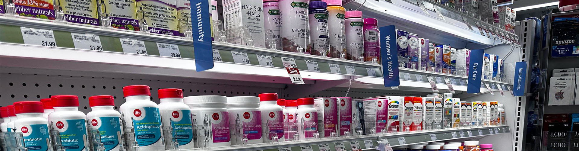 Banner featuring shelf of bottled vitamin supplements with signs designating categories